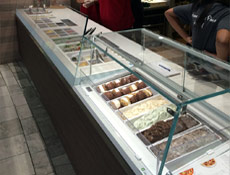 Custom gelato display with condiments counter